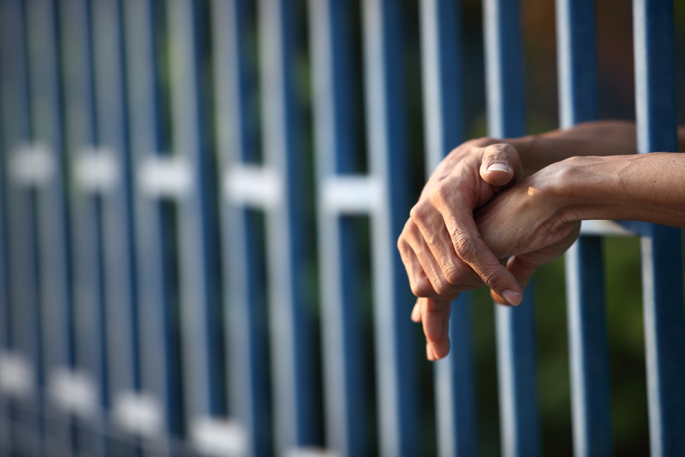 Hands in jail cell